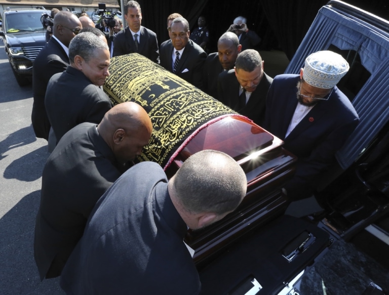 Men in suits lift Muhammad Ali's casket into hearse