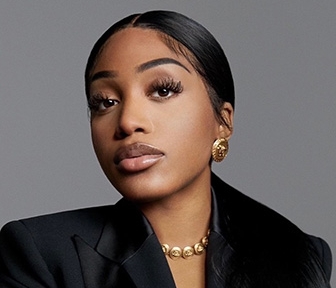 Woman in black blazer posing for camera