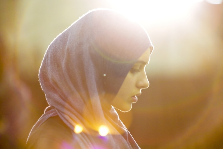 Woman with a headscarf looking down