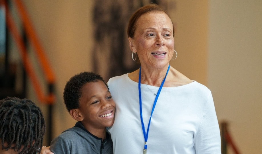 Lonnie Ali and young man smiling at camera for picture