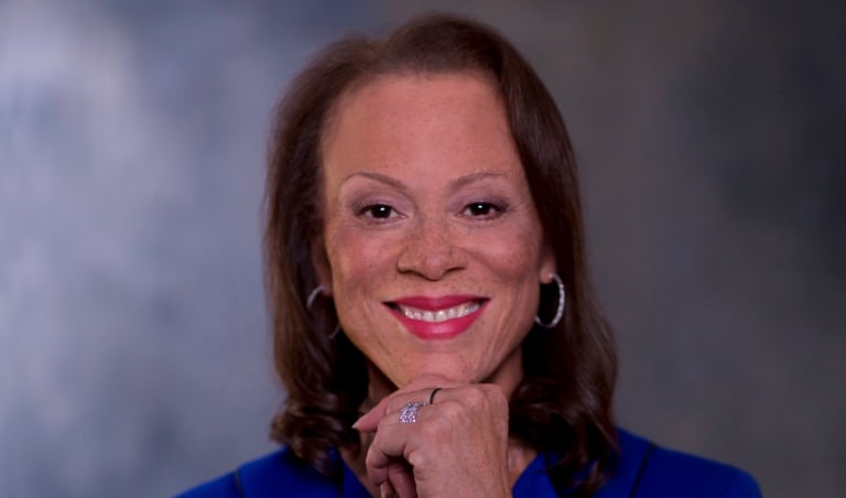 Lonnie Ali standing in a blue jacket