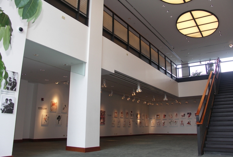 An empty art gallery with balcony and staircase