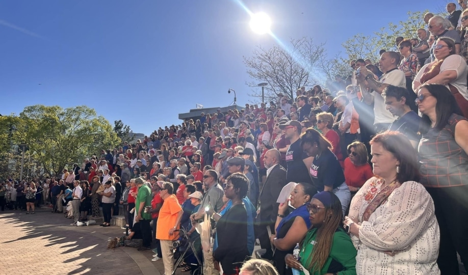 People attending vigil in open air gathering space