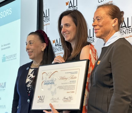Photo of Whitney Austin receiving Daughters of Greatness award from Lonnie Ali